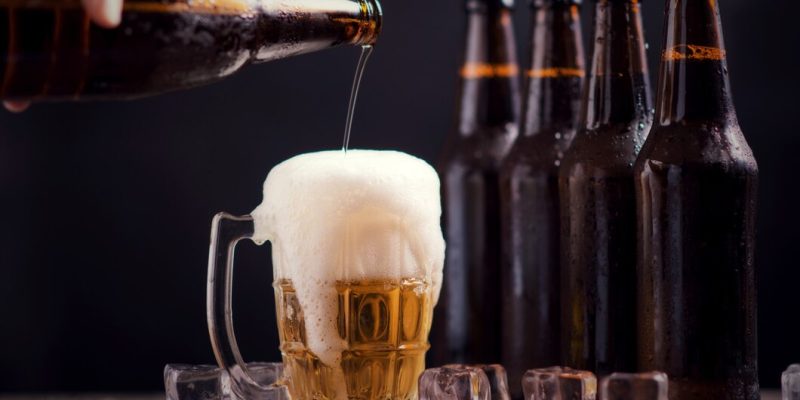 glass-bottles-beer-with-glass-ice-dark-background_1150-8899
